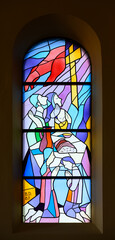 The prayer in the family. A stained-glass window in the St James Church in Medjugorje, Bosnia and Herzegovina.