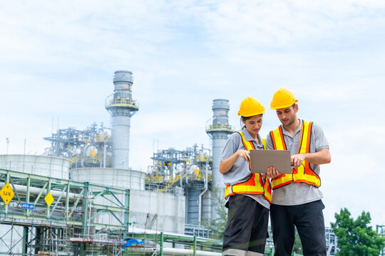 Petrochemical factory industry engineer teamwork meeting discussion at petroleum oil refinery plant. Industrial engineering technician working and maintenance manufacturing energy power gas system.