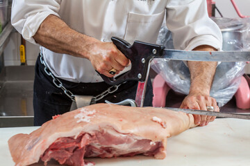 Butcher cutting meat