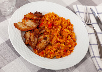 Appetizing pearl barley with cabbage served with fried brisket on platter
