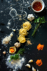 Deconstructed pasta dish with individual noodles, sauce, and garnishes highlighted
