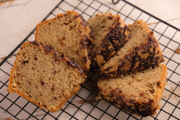Slice banana cake sprinkled with chocolate on a cooling rack. bolu pisang.