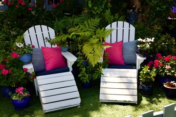White wood Adirondack chairs with pillows