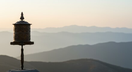 Serene Sunset: Prayer Wheel Against a Misty Mountain Range in Himalayas
