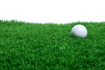 Golf ball on green grass against white background