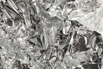 Crumpled aluminum foil as background, top view