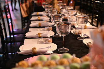 interior of restaurant, interior of restaurant in the evening, table setting, glasses on the table, wedding table setting, table set for a party, party hall, assembly room
