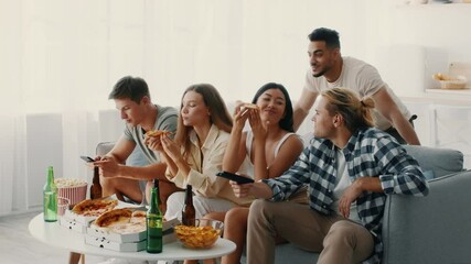 In a bright living room, a diverse group of friends share a relaxed evening filled with laughter, pizza, snacks, and drinks, all while engaging with their phones and each other. - Powered by Adobe