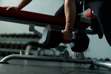 Healthy strong latina male holding dumbbells lifts weights exercise in gym. sport training weights...