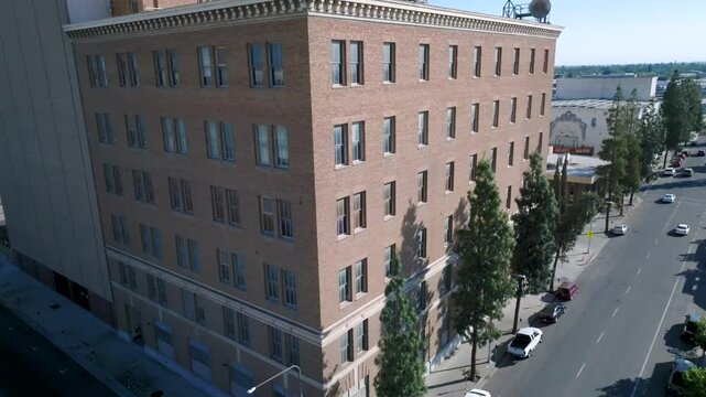 Aerial view over downtown Fresno, California, revealing a grid of streets, mid-rise buildings