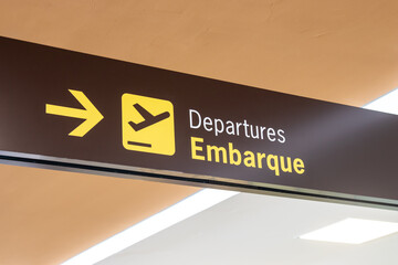 Sign indicating the boarding location at the airport.