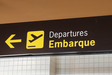 Sign indicating the boarding location at the airport.