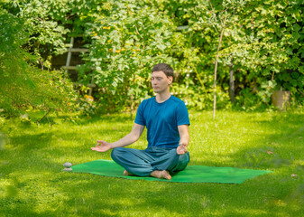 man meditating doing yoga exercises outdoors