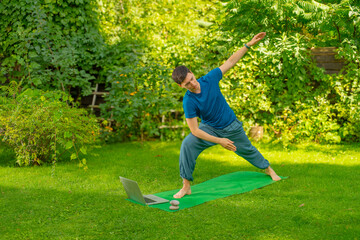 man meditating doing yoga exercises outdoors