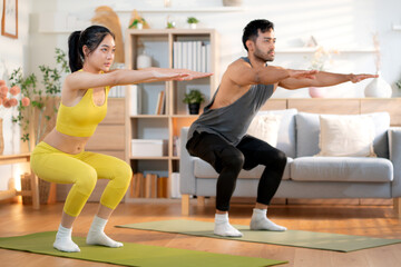 Fitness coach guidance with asian woman during squat training at home in living room, workout and...