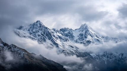 Fototapeta premium Marvel at Snow-Capped Mountain Peaks Emerging through Early Morning Clouds for Breathtaking Adventure Photography Inspiration