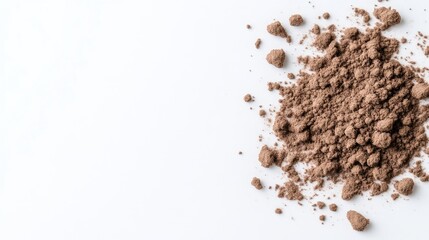 A pile of finely ground brown powder on a clean white surface, close-up composition highlighting texture and color, and minimalistic and abstract concept.
