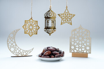 A Pile Of Dates Fruit On Plate With Islamic Decoration Isolated On White Background