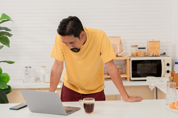 Asian bearded man introducing ingredients and cooking process communicating with subscribers...