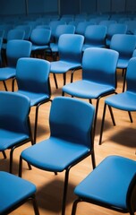 Obraz premium A spacious room filled with vibrant blue chairs arranged neatly, creating a lively atmosphere, perfect for gatherings or meetings. Soft lighting enhances the scene.
