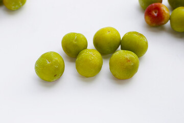 Fresh green plum on white background