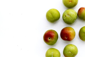 Fresh green plum on white background
