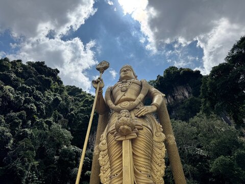 Selangor, Malaysia - April 20th 2025 : Batu caves a golden statue of murugan shines brightly