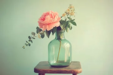 Pastel-toned floral arrangement in a vintage glass vase.