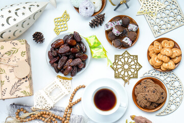 Top View Of Assorted Eid Mubarak Equipment With Iftar Food On White Background
