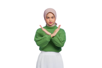 Beautiful annoyed Asian woman in green sweater crossing hands makes stop gesture, demonstrates rejection isolated on transparent background