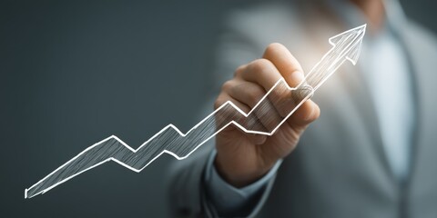 Fototapeta premium Businessman sketching growth graph with digital data on virtual screen, illustrating financial advertisement concept for corporate strategy and marketing technology.