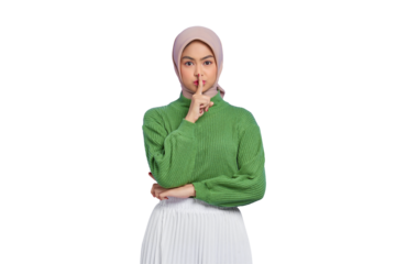 Beautiful young Asian woman in green sweater showing silence gesture with finger isolated on transparent background