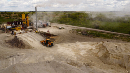 Aerial View of Industrial Site with Equipment and Smoke