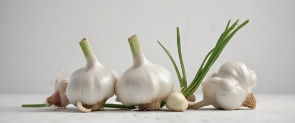 Several whole garlic bulbs, green stems intact, arranged neatly on white ,  healthy eating,  organic garlic