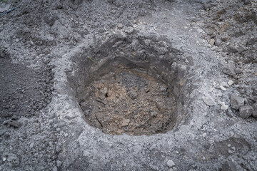 Naklejka premium A pit prepared for planting tree seedlings