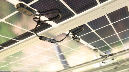 Solar cell connector. Close-up of Solar PV connector of solar cell circuit and wires under solar panel in smart farm with copy space and focus selection.