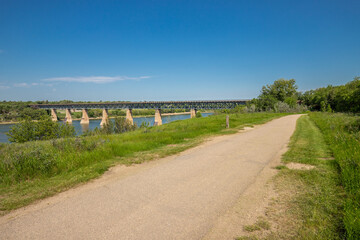 Bridge spans a river, with a path running alongside it