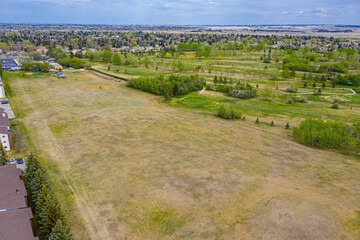 Large field with a few houses in the background
