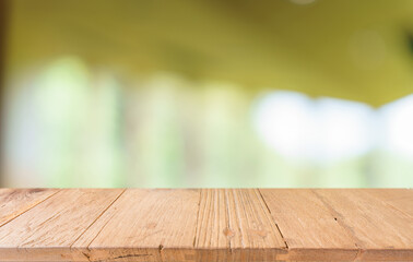 Empty wood table top and blur of restaurant background selective focus product display
