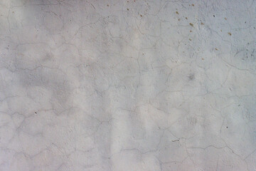 A weathered, time-damaged grey wall.