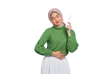 Hungry beautiful Asian woman in green sweater and hijab holding a spoon and think of tasty food isolated on transparent background