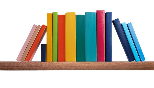 A row of colorful books arranged on a wooden shelf, showcasing various sizes and vibrant hues.