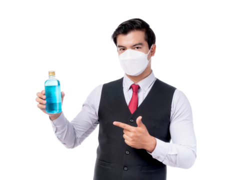 Confident young Asian man in formal attire wearing medical face mask pointing at blue alcohol bottle, promoting hygiene and safety , isolated on a transparent background during pandemic or health