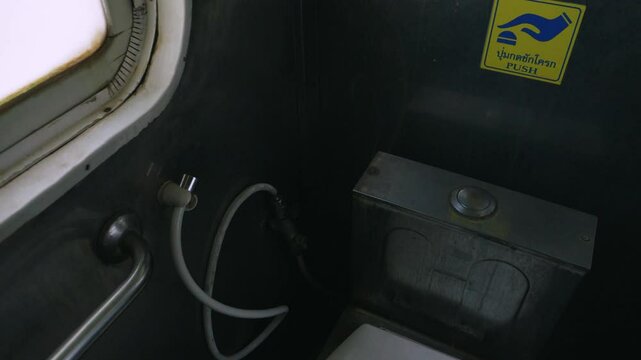 Handheld shot of train toilet in a Thailand's Eastern Line train from Bangkok to Ban Klong Luk during the day in Thailand