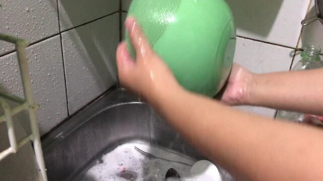 clean kitchen equipment after use, for example plates, spoons, forks and bowls