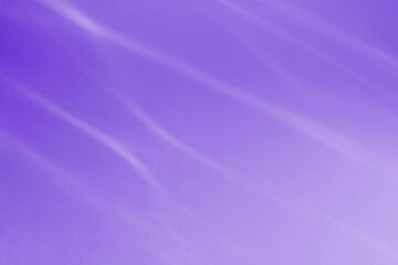 Light reflects on the water surface on the wall and blurs.