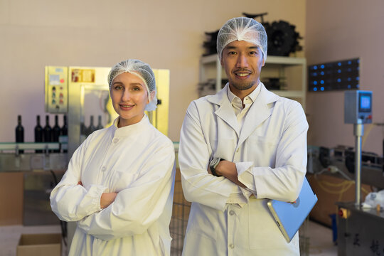 Winemaker inspecting quality the process of fermentation during manufacturing in winery factory