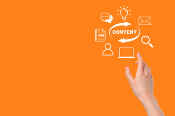 Hand points towards symbols representing content creation and digital communication tools