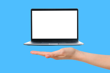 A hand holds up a laptop that appears to float, emphasizing innovative gadget design