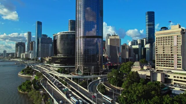 A stunning aerial view of Brisbane, Australia, showcasing the city's modern skyline, high-rise buildings, and bridges over the Brisbane River. The image captures the vibrant urban landscape